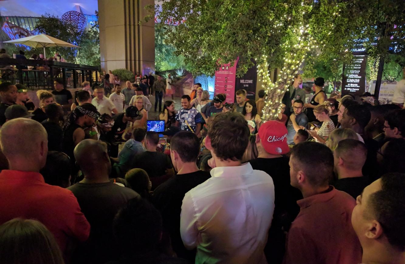 Fans without tickets for the arena or the sold-out bars that were showing the fight gather around a laptop outside Shake Shack, Las Vegas, Aug. 26.