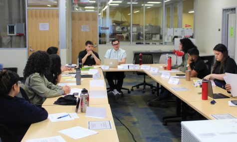 Sebastian Dunne and Andrew Leal at the head of a conference room table