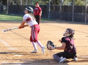 City College softball player looks to the outfield after she hit the ball.