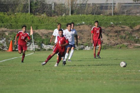 A Knights player runs after the soccerball ahead of teammates and opponents. 